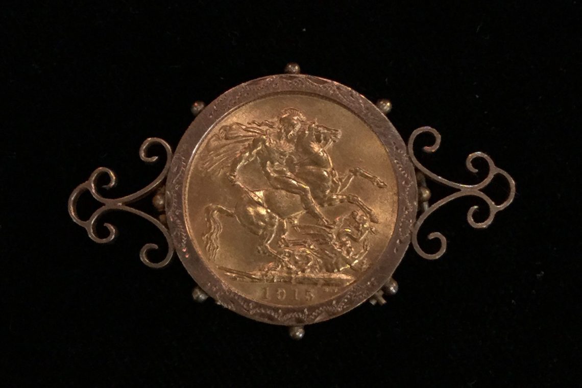 antique gold sovereign coin in antique brooch pin
